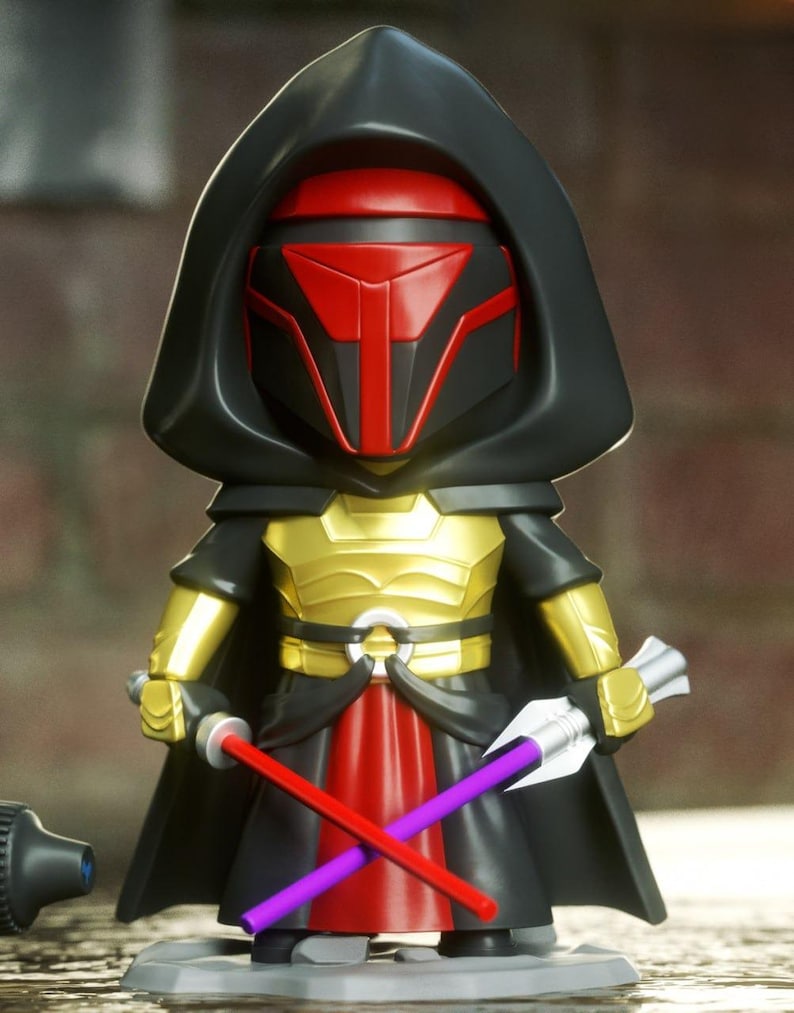 May include: A stylized figurine of a character wearing a black hooded cloak, a red and black mask, and gold chest armor. The figure holds a red lightsaber in one hand and a purple lightsaber in the other, with a red fabric-like skirt piece.