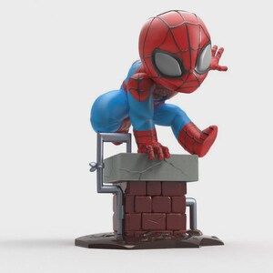 May include: A stylized figurine of a superhero character with a large head, wearing a red and blue suit with a black web pattern. The character is crouched on top of a brown brick chimney with a gray top, featuring a small gray pipe attached to the side.