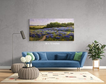 May include: A painting of a field of purple wildflowers with a dirt path leading through the center. The painting is framed and hanging on a gray wall above a blue sofa. The painting is 36 x 72 inches.