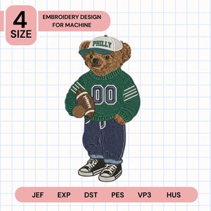 May include: An embroidery design for machine featuring a brown teddy bear wearing a white and green cap with the text PHILLY, a green sweater with the number 00, dark blue pants, and black sneakers, while holding a brown football in its right arm.