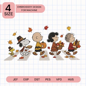 May include: Machine embroidery design featuring Snoopy, Woodstock, Charlie Brown, Lucy, and Linus walking across a crosswalk. They carry autumn items like a pumpkin, pie, and corn. Falling orange and yellow leaves surround them.