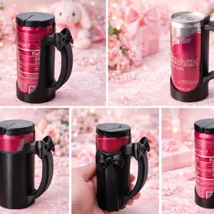 May include: A black can holder with a handle and a lid, designed to hold a beverage can. The holder is shown with a red can inside. The handle has a decorative bow. The background is pink with gifts and flowers.