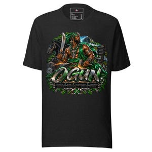 May include: A black t-shirt featuring a graphic print of a figure holding a machete and hammer, with the text OGUN, STRENGTH, WORK, TECHNOLOGY, PROGRESS, CLEAR PATHS, HIGHER PURPOSE, STRONGER TOMORROW, DISCIPLINE, BUILDS, and FREEDOM in a green and metallic design.