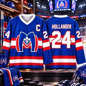 May include: A blue hockey jersey featuring a white V-neck, red and white horizontal stripes, and a large central logo with a fleur-de-lis and the text ESTO 1909. The front displays the letter C, while the back shows the name HOLLANDER and number 24.