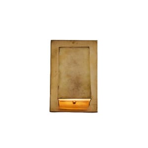 May include: A rectangular wall sconce made of brushed brass with a metallic finish. The fixture features a flat, solid front panel that extends outward from a rectangular backplate, with a warm light emitting from the bottom opening of the unit.