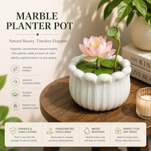 May include: White marble planter pot with a lotus flower and lily pads. The pot has a scalloped edge and the text "MARBLE PLANTER POT" is at the top. The planter is perfect for indoor plants and is handcrafted.