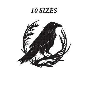 May include: A black embroidery design featuring a raven perched on a branch within a circular frame of leaves. The text 10 SIZES is positioned above the bird. The design is rendered in a solid black color against a plain white background.