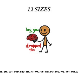 May include: An embroidery design featuring a brown stick figure holding a red brain. The text reads "hey, you" in green and "dropped this" in red. The top text says "12 SIZES" and the bottom lists file formats: EMB, EXP, DST, CND, BRO, STX, JEF, JPX, SEW, ART, PES, PEC, VP3, HUS, PCS, XXX.