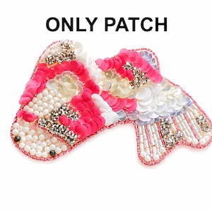 May include: A decorative patch with a unique design. The patch features a combination of pink sequins, white and gold embellishments, and small white beads. The text "ONLY PATCH" is displayed above the patch.