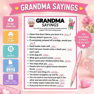 May include: A printable game sheet titled Grandma Sayings featuring fifteen fill-in-the-blank phrases with a cartoon illustration of an elderly woman. The white paper has a pink border and is accompanied by a pink pen and a small pink heart-shaped object.