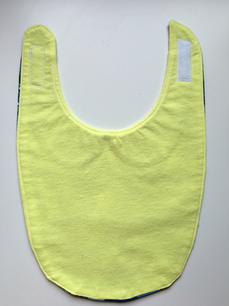 Blue floral pattern hipster girl baby bib with navy peter ...