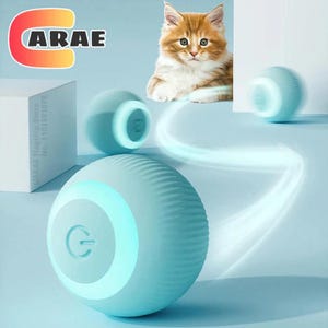 May include: A light blue, spherical, textured electronic pet toy with a power button symbol on the front. The device emits a glowing light and is shown in motion with a blurred trail. A ginger and white kitten is visible in the background.