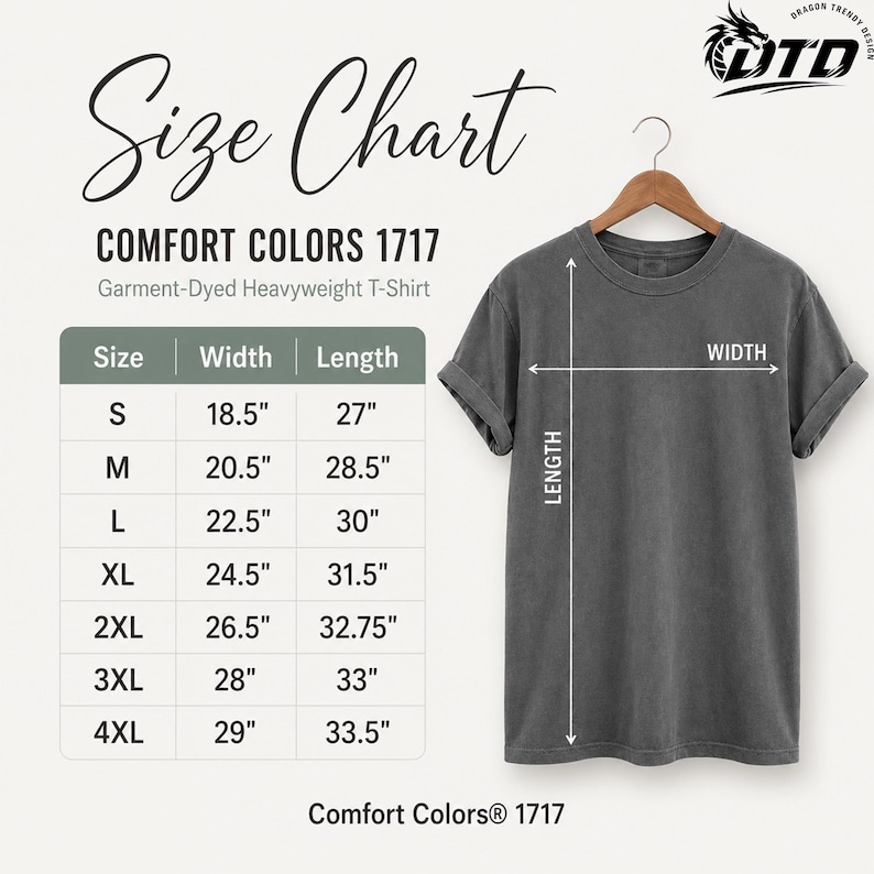 K&ouml;nnte beinhalten: Ein anthrazitfarbenes Comfort Colors 1717 T-Shirt aus schwerem, st&uuml;ckgef&auml;rbtem Stoff auf einem Holzkleiderb&uuml;gel neben einer Gr&ouml;&szlig;entabelle. Die Tabelle f&uuml;hrt die Gr&ouml;&szlig;en S bis 4XL mit den entsprechenden Breiten- und L&auml;ngenma&szlig;en in Zoll auf.