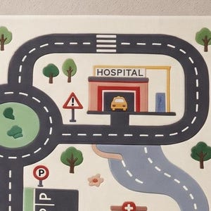 May include: A play mat featuring a printed city map with dark gray roads, white dashed lane markings, a hospital building with a yellow car, green trees, a parking sign, and a triangular warning sign on a light cream-colored background.