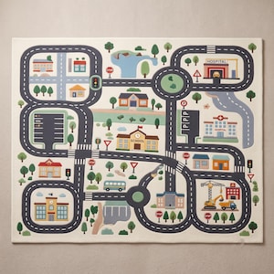 May include: A rectangular play rug featuring a printed city map with dark gray roads, traffic lights, and various buildings including a school, hospital, and fire station. The design includes green trees, blue water features, and stop signs on a cream background.