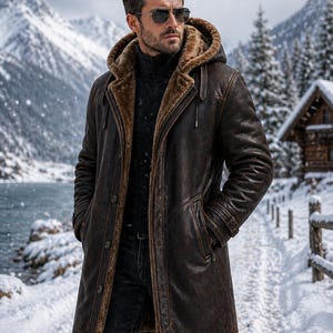 May include: A brown leather coat with a fur-lined hood and interior. The coat has a button-up front, pockets, and a belt. The person is wearing sunglasses and a black turtleneck. The background features a snowy mountain landscape.