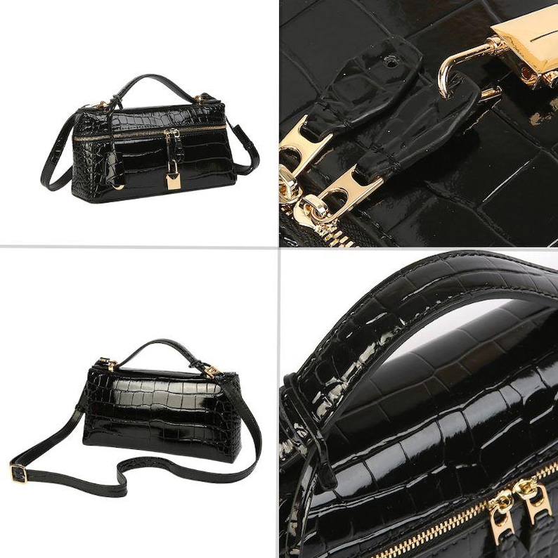 May include: A black handbag with a glossy crocodile-embossed texture, featuring a top handle, a detachable shoulder strap, gold-tone metal hardware, a zippered closure, and a small gold padlock attached to the front of the bag.