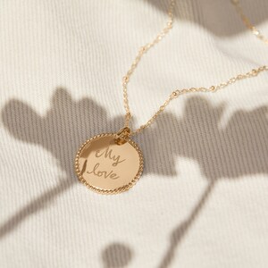 May include: A gold necklace with a round pendant that says "My love" in cursive handwriting.