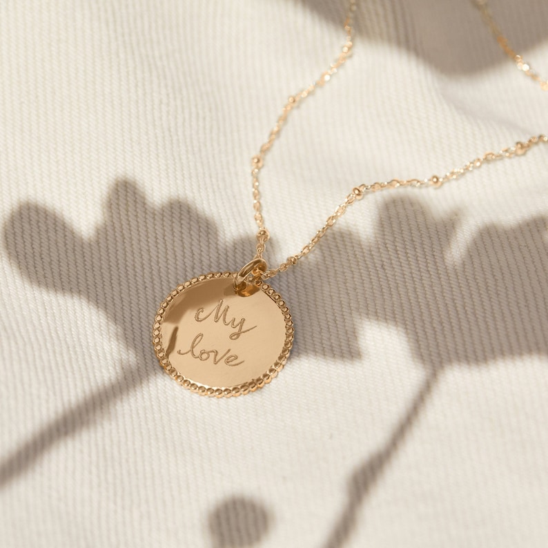 May include: A gold necklace with a round pendant that says "My love" in cursive handwriting.