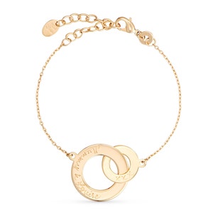 May include: Gold chain bracelet with two interlocking circles. The larger circle has the inscription "I know you'll always be there for me" and the smaller circle has the inscription "xxx".