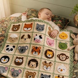 Puede incluir: Una manta de bebé de ganchillo de color crema que presenta una cuadrícula de veinticuatro caras de animales distintas, incluyendo un oso, zorro, gato, oveja, perro, vaca, cerdo, pollito, panda, koala, tigre, león, mono, pingüino y búho.