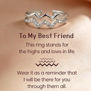 May include: A silver-toned open ring featuring a double-layered zigzag design with small clear stones embedded along the lower band. The text reads: To My Best Friend, This ring stands for the highs and lows in life, Wear it as a reminder that I will be there for you through them all.