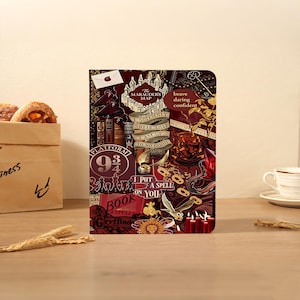 May include: A rectangular notebook featuring a dark red and gold collage design with text including The Marauder's Map, I solemnly swear that I am up to no good, Platform 9 3/4, Book of Spells, Gryffindor, and I put a spell on you with various magical icons.