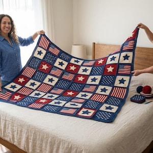 May include: A handmade crochet blanket featuring a patriotic design with red and white stripes, white stars, and blue squares. The blanket is displayed on a bed, showcasing its intricate pattern and craftsmanship. The color scheme is red, white, and blue.