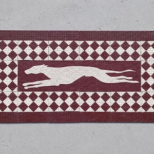 May include: Rectangular mosaic tile with a running greyhound silhouette in the center. The tile has a burgundy border and a white and burgundy diamond pattern. The background is a light grey.