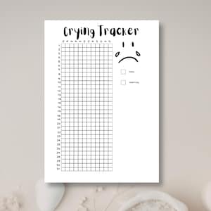 May include: A white paper tracker sheet titled Crying Tracker in black text. It features a grid with months J through D across the top and numbers 1 through 31 down the side. A sad face icon with two teardrops is on the right with two checkboxes.