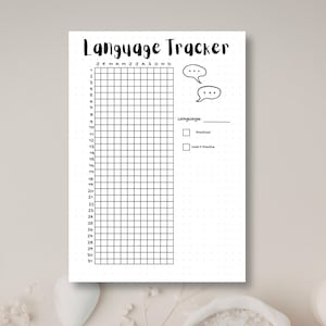 May include: A white paper sheet with a black grid titled Language Tracker. The grid features columns for months J through D and rows numbered 1 through 31. It includes two speech bubble icons, a line for Language, and checkboxes for Practiced and Didn't Practice.