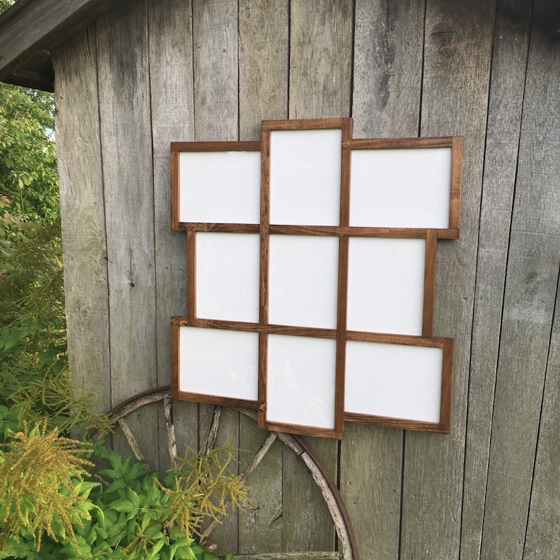 May include: A rustic wooden picture frame with nine openings, arranged in a unique geometric pattern. The frame is stained a dark brown color and has a distressed finish.