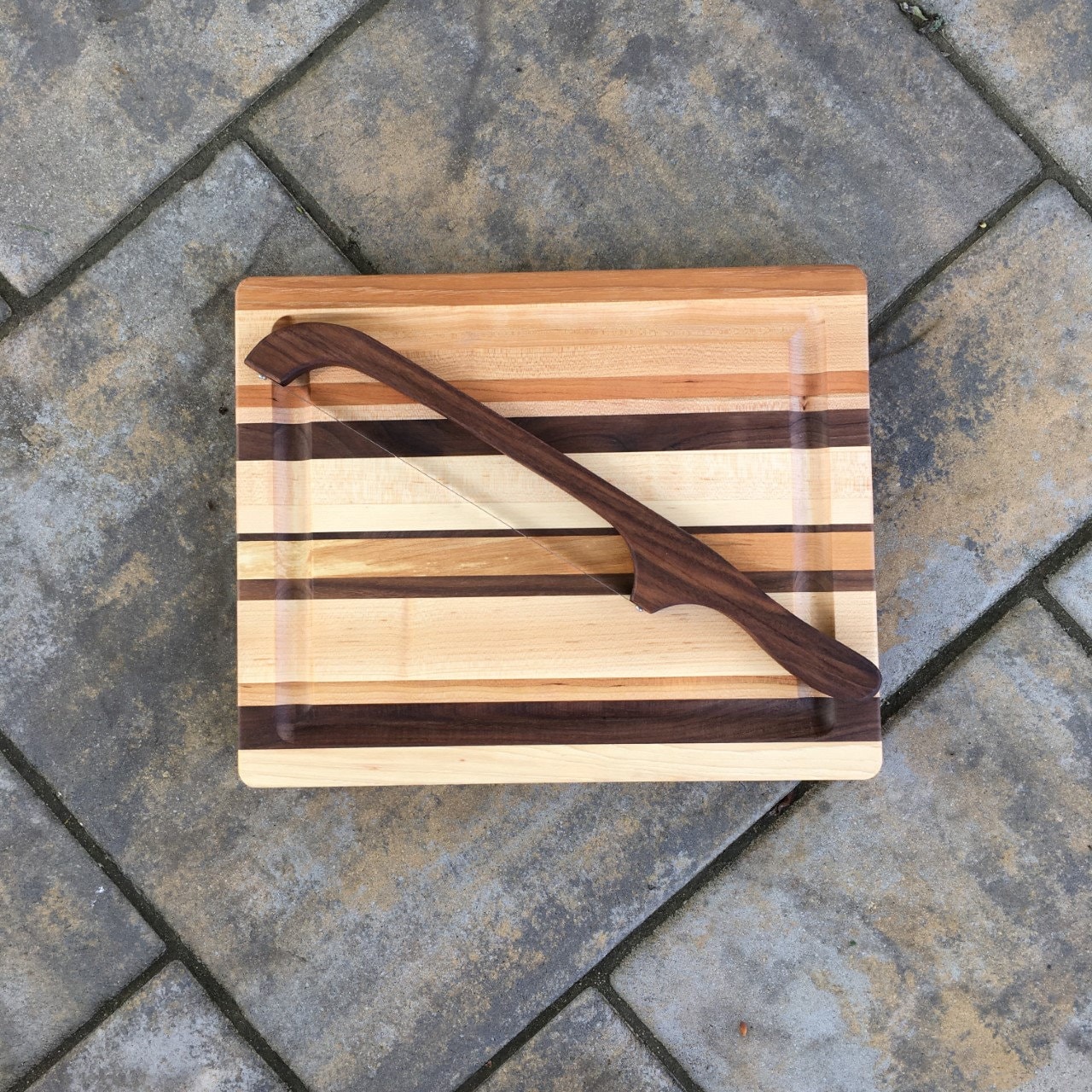 Cutting board with moat outlet