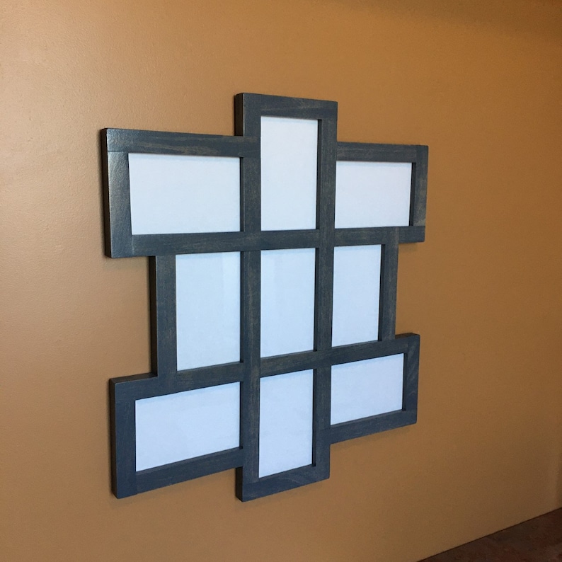 May include: A dark gray wooden picture frame with nine openings for photos. The frame is arranged in a grid pattern and has a distressed finish.