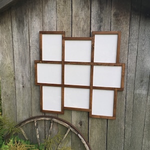 May include: A wooden picture frame with nine openings, each with a white background. The frame is stained a dark brown color and has a rustic appearance.