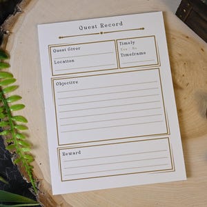 May include: A white "Quest Record" sheet with gold-colored text and lines, designed for role-playing games. The sheet includes sections for "Quest Giver," "Location," "Objective," and "Reward." Various polyhedral dice are scattered around the sheet.