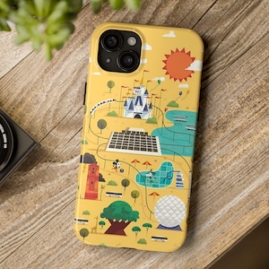 May include: A yellow smartphone case featuring a colorful illustrated map of a theme park. The design includes a white castle, a large geodesic sphere, a red tower, a swimming pool, green trees, a bright orange sun, and a winding monorail track.