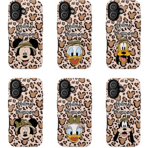 May include: Six phone cases featuring a tan and brown leopard print background with hidden Mickey shapes. Each case displays the text Animal Kingdom and a different cartoon character wearing a safari hat, including Mickey, Donald, Pluto, Minnie, Daisy, and Goofy.
