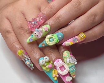 May include: Long, pointed acrylic nails featuring a vibrant 3D design. The nails are decorated with colorful charms including miniature digital pet devices, small animal figures, stars, hearts, and letter blocks in shades of pink, blue, green, and yellow.