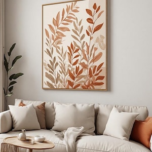 May include: A rectangular wall art print featuring a botanical illustration of various leafy branches in shades of terracotta, rust, and muted beige. The artwork is displayed in a thin wooden frame and depicts overlapping foliage patterns.