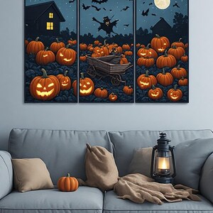 May include: A three-panel wall art set depicting a nighttime Halloween scene with glowing orange jack-o'-lanterns in a field, a wooden cart, a dark house, bats flying in the sky, and a full moon, all framed in thin black borders on a wall.