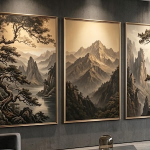 May include: A triptych of framed wall art featuring sepia-toned mountain landscapes. The left panel shows a lake with pine trees, the centre panel depicts jagged mountain peaks, and the right panel displays a tall, gnarled pine tree on a cliff.
