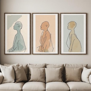 Peut inclure: Trois cadres muraux présentant des illustrations au trait de silhouettes de profil. L'impression de gauche a un fond vert sauge, celle du centre est pêche et celle de droite est bleu clair. Chaque silhouette est tracée d'un trait noir continu.