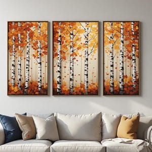 May include: A triptych wall art set featuring three vertical canvases depicting a forest of birch trees with white and black bark. The trees are surrounded by vibrant orange and yellow autumn leaves, with a light cream background.