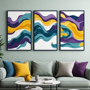 Peut inclure: Un ensemble de trois impressions d'art mural rectangulaires présentant des lignes ondulées abstraites dans des tons de violet, jaune moutarde, bleu sarcelle et blanc. Chaque impression est encadrée d'un cadre sombre fin, affichant des motifs fluides.