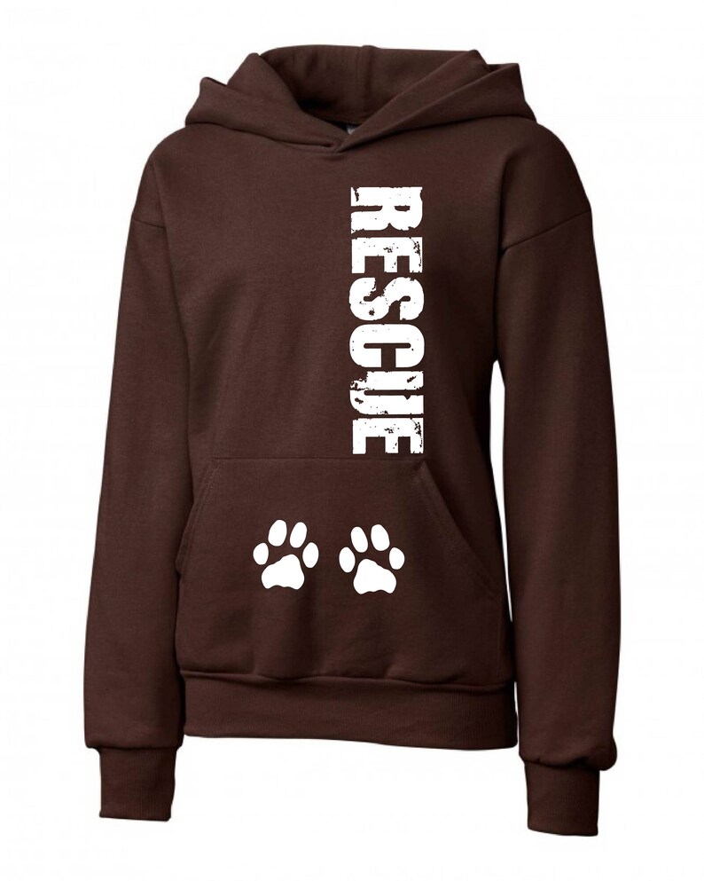 May include: Brown hooded sweatshirt with the word "RESCUE" printed vertically down the front in white. Two white paw prints are printed below the word.