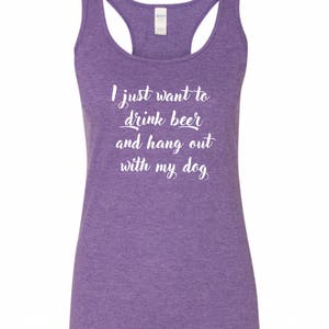 May include: Purple racerback tank top with the text "I just want to drink beer and hang out with my dog" in white.