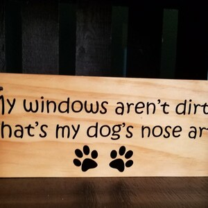 May include: Wooden sign with the text "My windows aren't dirty, That's my dog's nose art!" and two black paw prints.