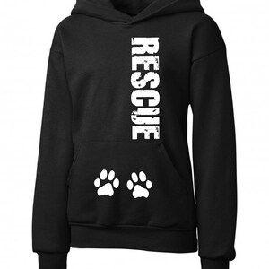 May include: Black hooded sweatshirt with the word "RESCUE" printed vertically down the center in white. Two white paw prints are printed below the word.