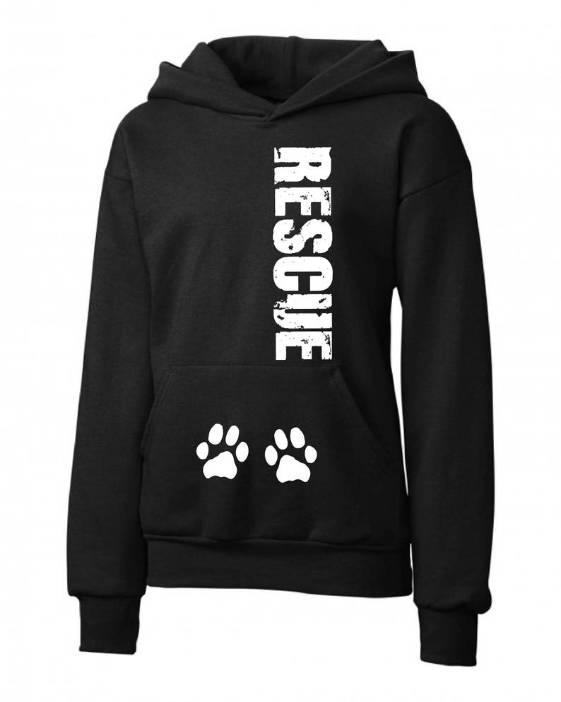 May include: Black hooded sweatshirt with the word "RESCUE" printed vertically down the center in white. Two white paw prints are printed below the word.